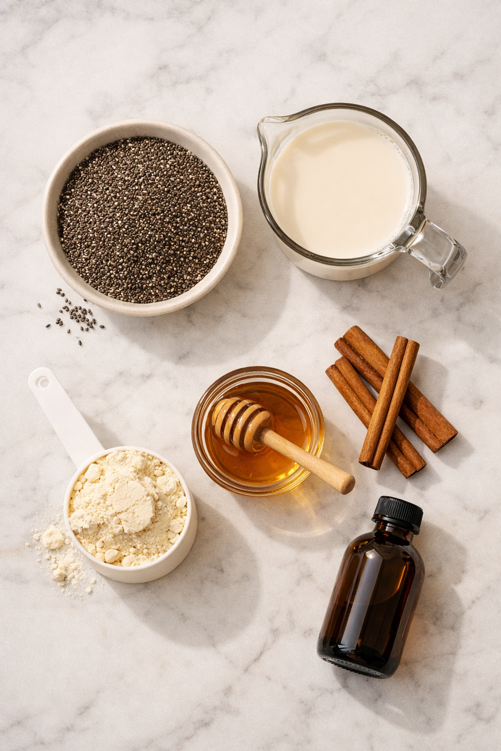 Portrait/Pinterest format () flat-lay overhead shot of all raw ingredients for protein chia seed pudding spread across a